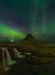 Kirkjufell illuminated by the Aurora Borealis.